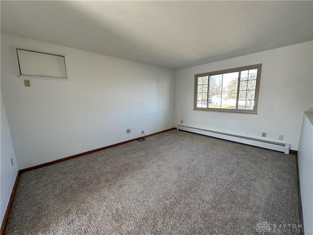 empty room with baseboards, carpet floors, and a baseboard radiator