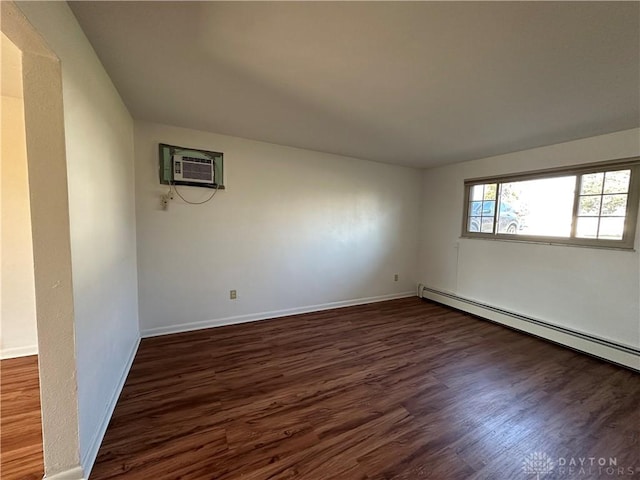 empty room featuring baseboards, a baseboard radiator, dark wood-style flooring, and a wall mounted AC