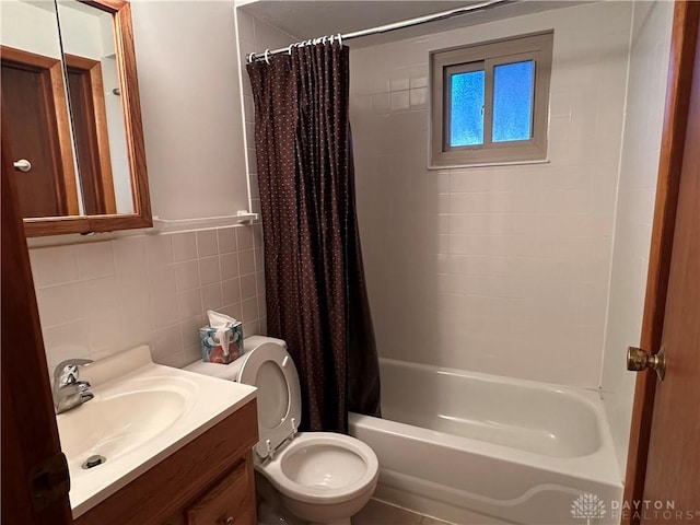 full bath with vanity, tile walls, shower / tub combo, and toilet