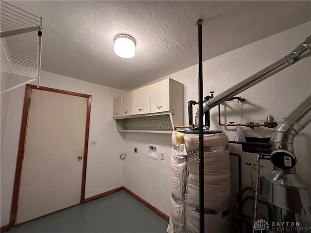 laundry room featuring washer hookup, a textured ceiling, water heater, cabinet space, and baseboards