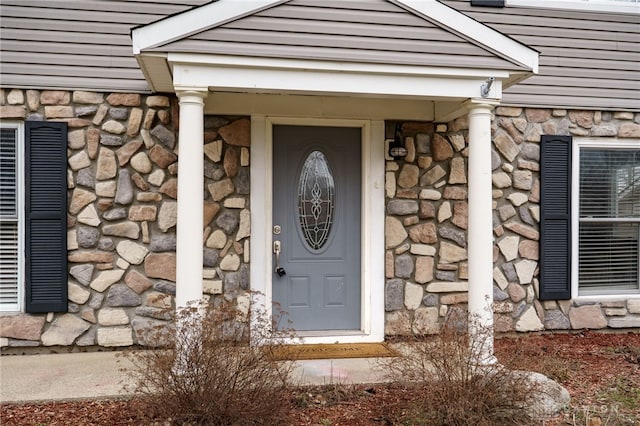 property entrance featuring stone siding