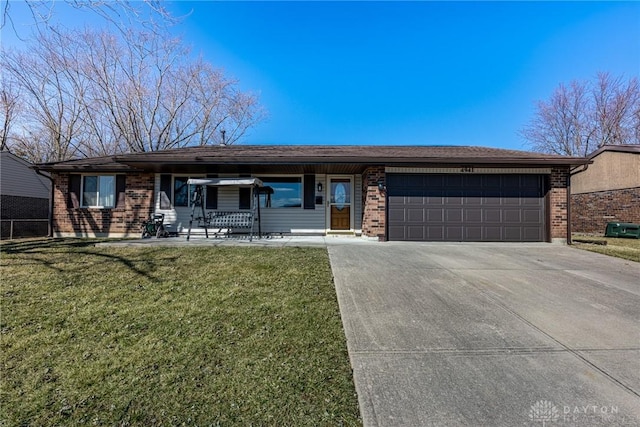 single story home with brick siding, a garage, driveway, and a front lawn