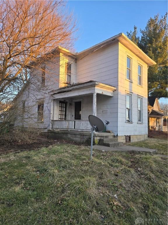 view of front of property with a porch and a front yard