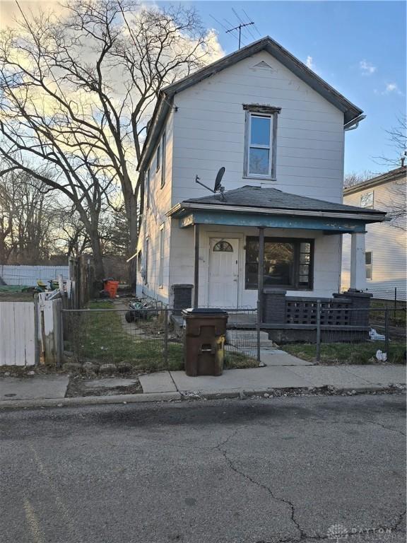 view of front facade featuring a fenced front yard, a porch, and a gate