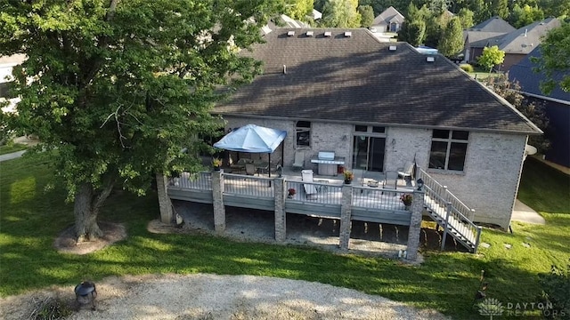 exterior space with stairs, a yard, and a wooden deck