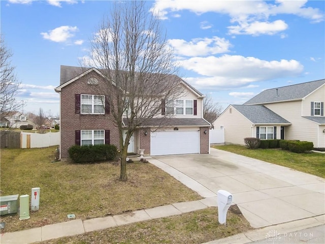 traditional-style house with brick siding, a front lawn, fence, driveway, and an attached garage