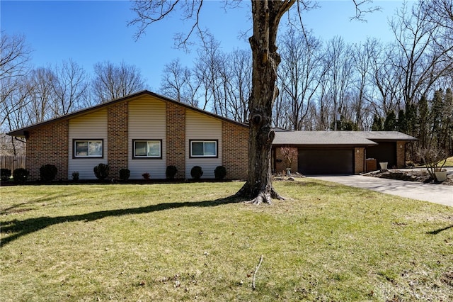 view of front of property with brick siding, an attached garage, concrete driveway, and a front lawn