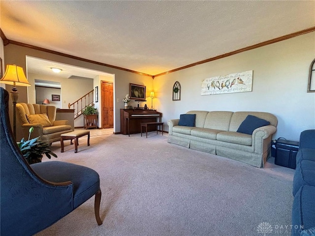 carpeted living room with a textured ceiling, stairs, and ornamental molding