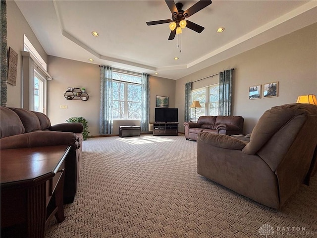 living area with recessed lighting, a raised ceiling, carpet floors, and ceiling fan