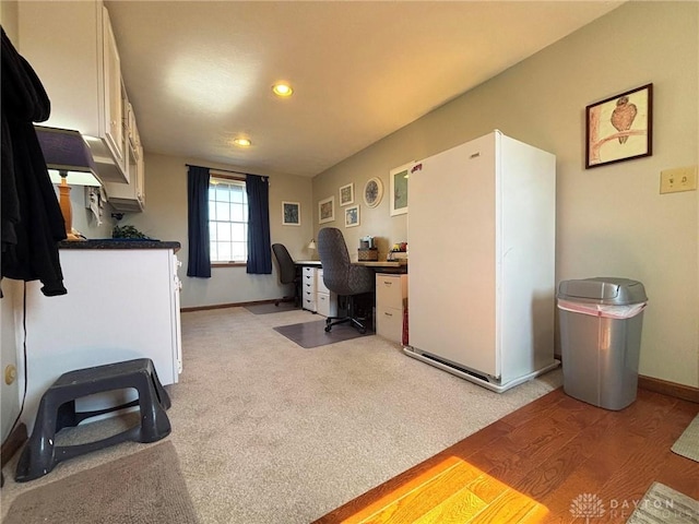 office space with light carpet, recessed lighting, and baseboards