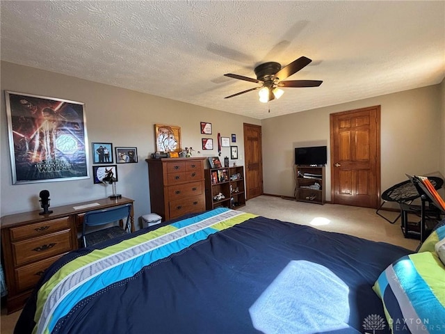 carpeted bedroom featuring a textured ceiling and ceiling fan