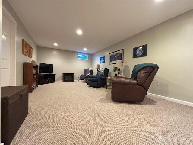 carpeted living area featuring recessed lighting and baseboards