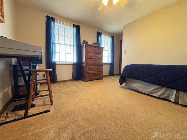 bedroom featuring baseboards, light carpet, and a ceiling fan