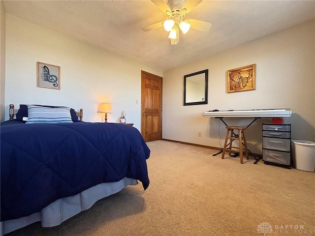 bedroom with a textured ceiling, a ceiling fan, baseboards, and light carpet