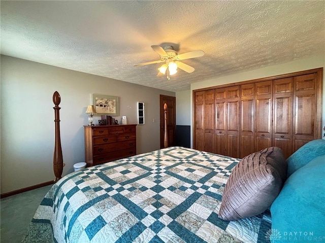 carpeted bedroom with a textured ceiling, baseboards, a closet, and ceiling fan