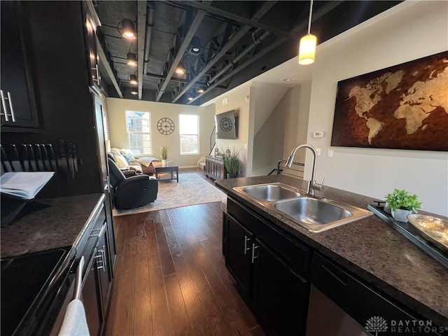 kitchen featuring a sink, electric range, dark wood-style floors, and dark cabinetry