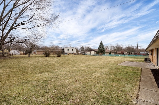 view of yard featuring a patio area, fence, and central AC