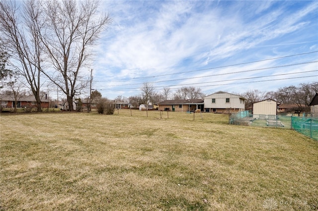 view of yard featuring an outbuilding and fence