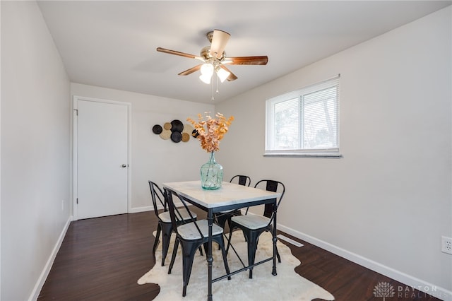 dining area featuring wood finished floors, baseboards, and ceiling fan