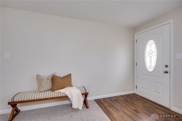 entryway with dark wood-type flooring and baseboards