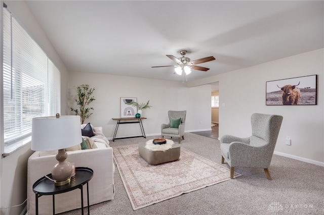 carpeted living room with plenty of natural light, baseboards, and ceiling fan