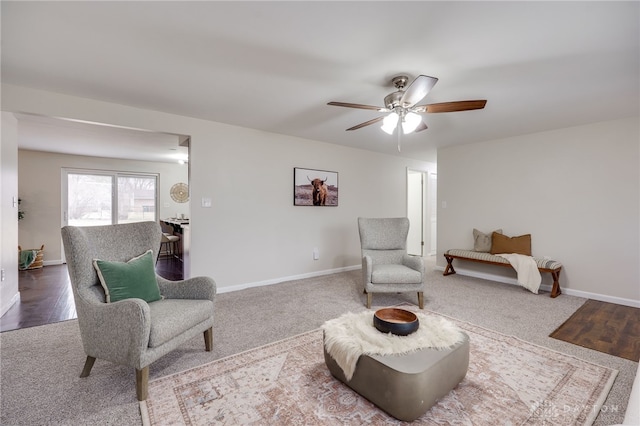 sitting room featuring baseboards and ceiling fan