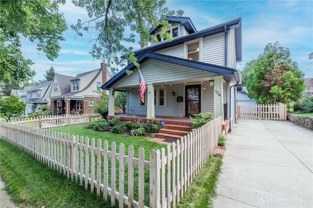 view of front facade featuring a porch, fence private yard, and concrete driveway