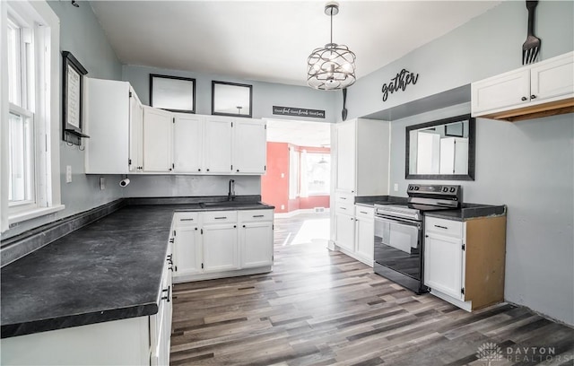 kitchen featuring dark countertops, electric range, white cabinets, and dark wood-style flooring