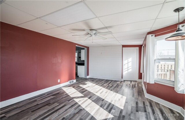 spare room featuring ceiling fan, visible vents, a paneled ceiling, and wood finished floors