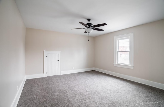 empty room featuring carpet flooring, baseboards, and ceiling fan