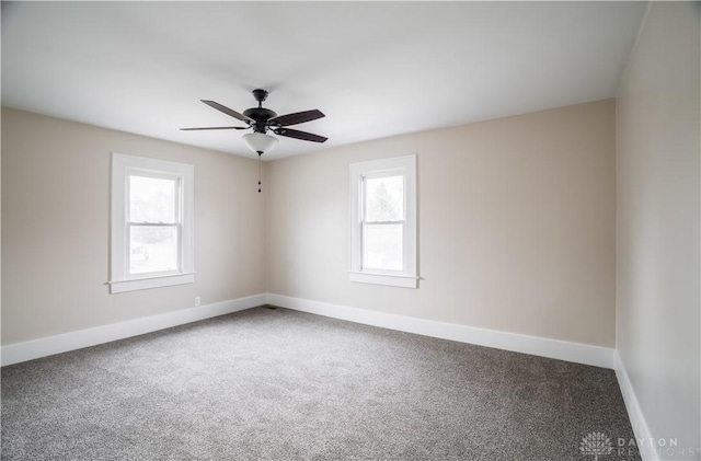 empty room featuring a ceiling fan, baseboards, and carpet floors