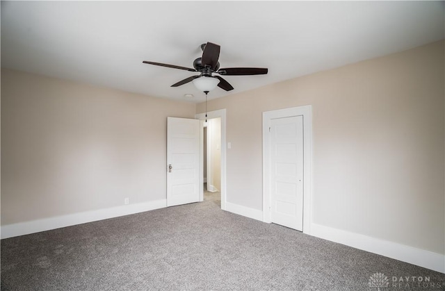 unfurnished bedroom featuring carpet flooring, a ceiling fan, and baseboards