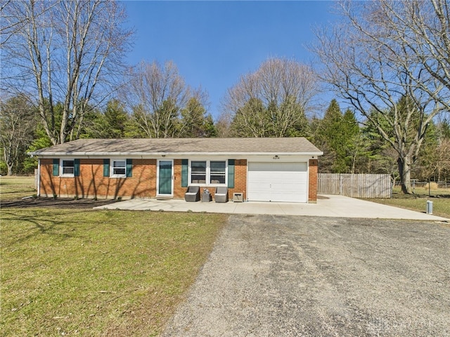 ranch-style home featuring brick siding, an attached garage, a front lawn, fence, and driveway