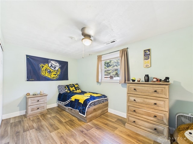 bedroom with baseboards, visible vents, and light wood-type flooring