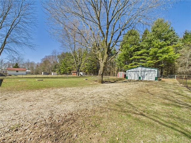 view of yard featuring an outbuilding and fence