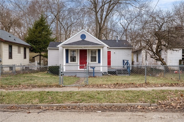 view of front of home with a front lawn, a gate, a fenced front yard, roof with shingles, and covered porch