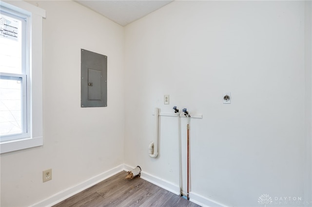 clothes washing area with laundry area, electric panel, plenty of natural light, and hookup for an electric dryer