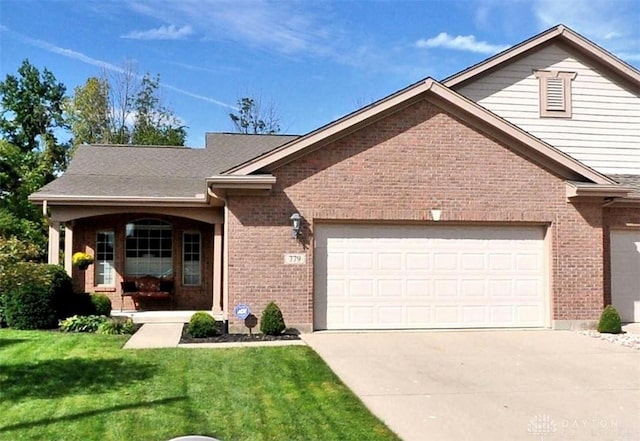 single story home featuring a front yard, an attached garage, brick siding, and driveway