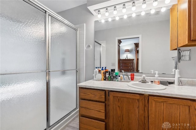 full bathroom with vanity and a shower stall