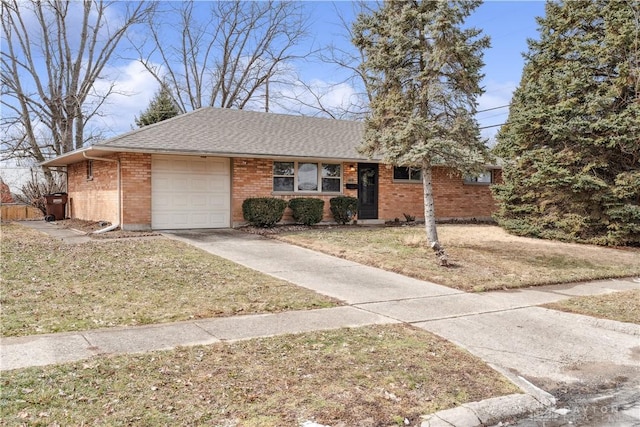 ranch-style home with roof with shingles, concrete driveway, a front lawn, a garage, and brick siding