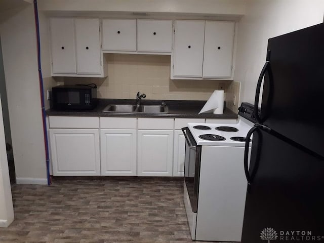 kitchen featuring dark countertops, white cabinets, black appliances, and a sink