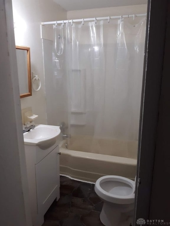 full bath featuring toilet, vanity, and shower / bath combination with curtain