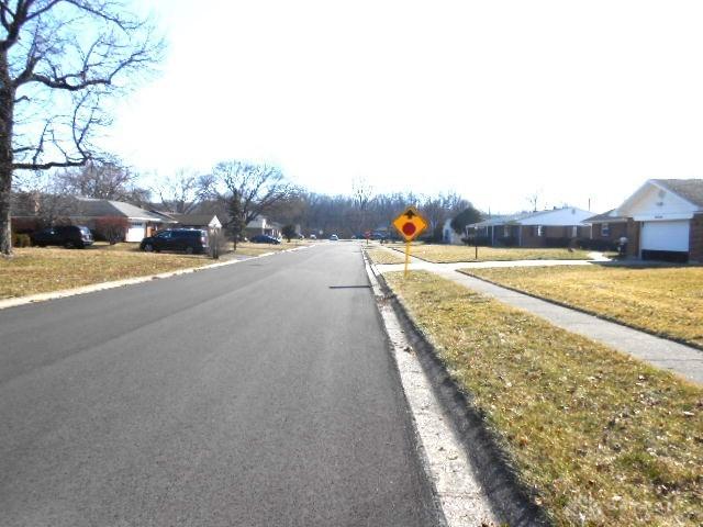 view of road with traffic signs and a residential view