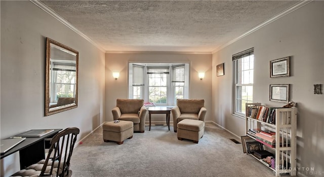 living area with a healthy amount of sunlight, a textured ceiling, carpet, and ornamental molding