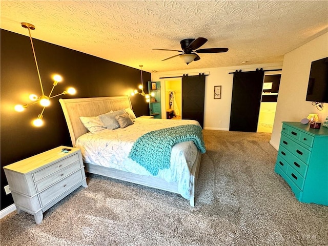 carpeted bedroom featuring a barn door, a textured ceiling, and ceiling fan