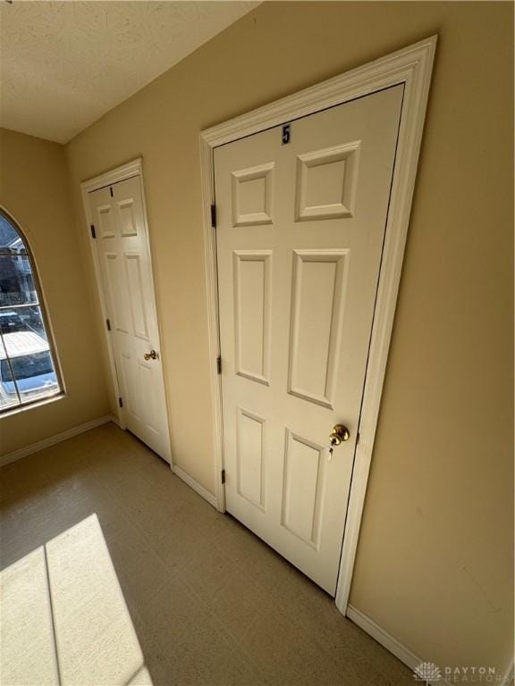 unfurnished bedroom featuring baseboards and light floors