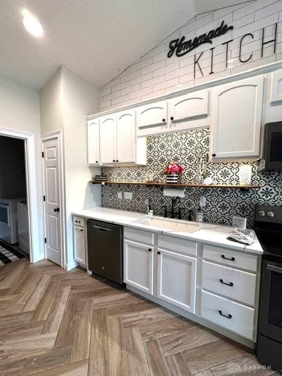 kitchen with black appliances, a sink, white cabinetry, decorative backsplash, and lofted ceiling