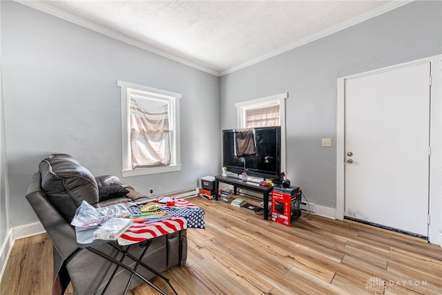 living room featuring a baseboard radiator, baseboards, wood finished floors, and crown molding