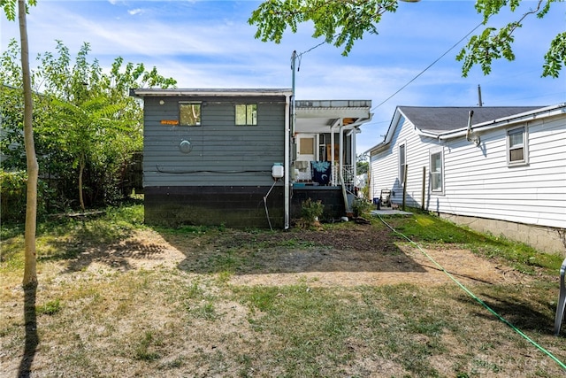 rear view of house featuring covered porch