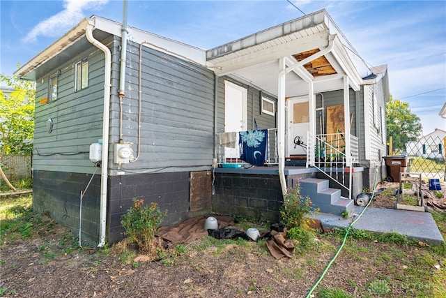 view of side of property with covered porch